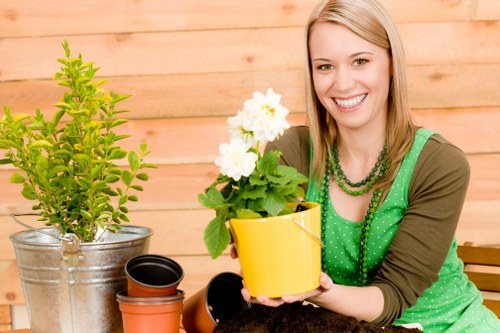 Ava Gardening expert trimming a flowering hedge